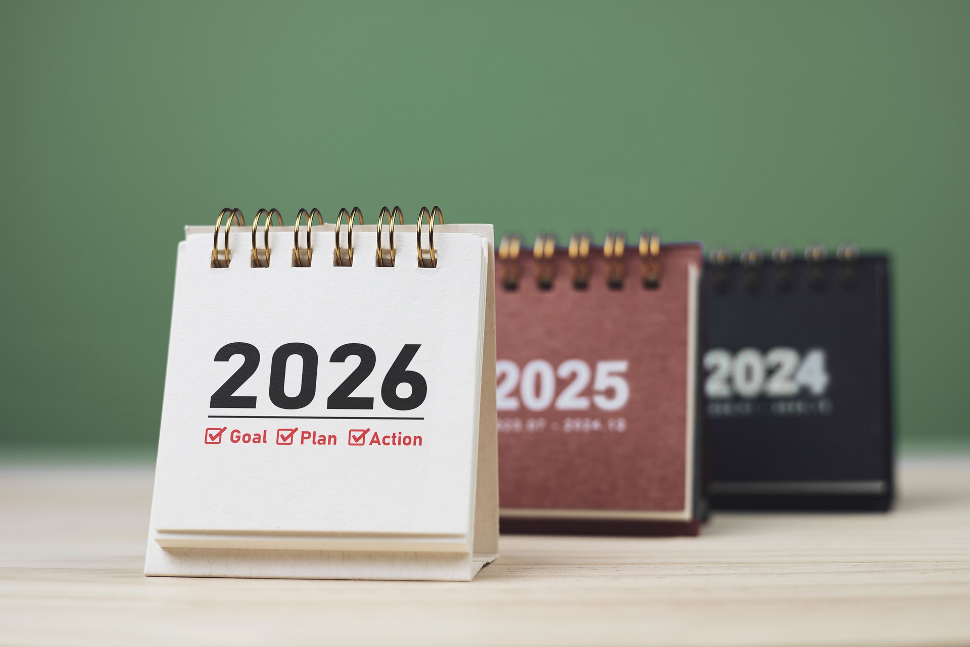 Calendar page of 2026, white on wooden table. Concepts of planning for success